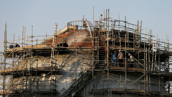 Workers are seen at the damaged site of Saudi Aramco oil facility in Abqaiq, Saudi Arabia, September 20, 2019 - Sputnik International