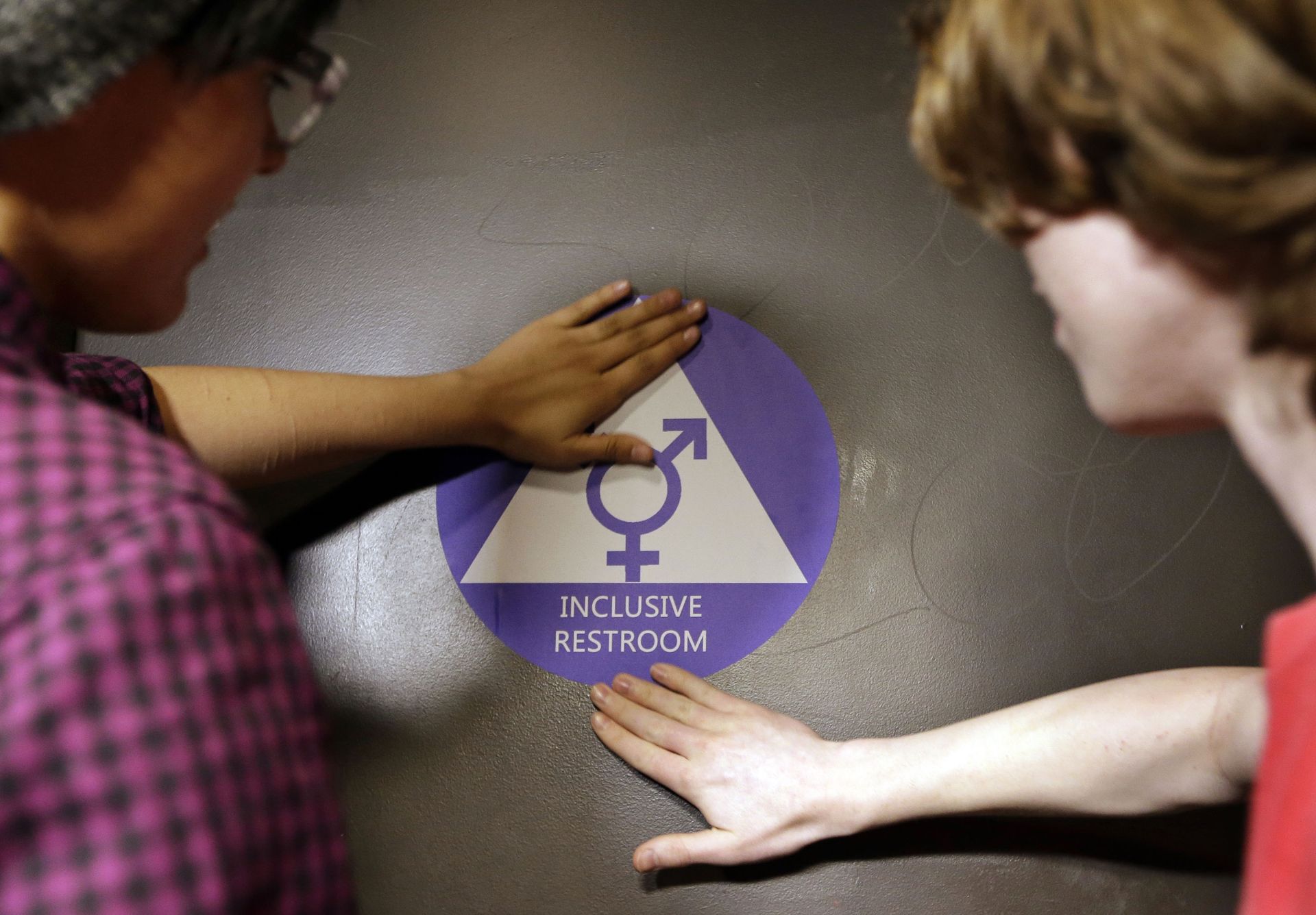 Destin Cramer, left, and Noah Rice place a new sticker on the door at the ceremonial opening of a gender neutral bathroom at Nathan Hale high school Tuesday, May 17, 2016, in Seattle Destin Cramer, left, and Noah Rice place a new sticker on the door at the ceremonial opening of a gender neutral bathroom at Nathan Hale high school Tuesday, May 17, 2016, in Seattle - Sputnik International, 1920, 18.09.2021