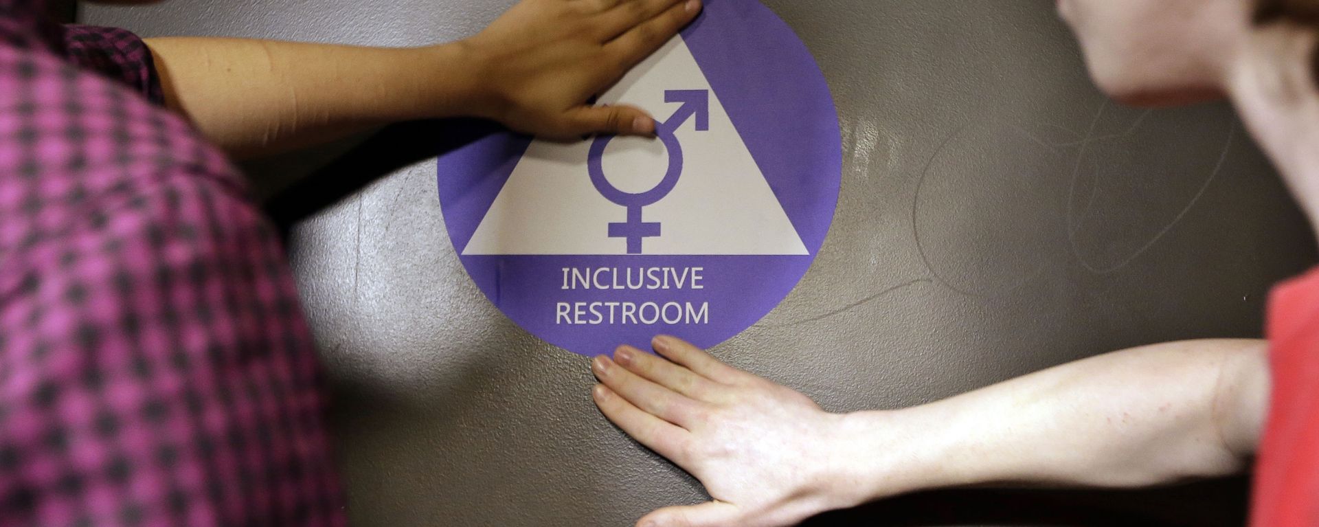 Destin Cramer, left, and Noah Rice place a new sticker on the door at the ceremonial opening of a gender neutral bathroom at Nathan Hale high school Tuesday, May 17, 2016, in Seattle Destin Cramer, left, and Noah Rice place a new sticker on the door at the ceremonial opening of a gender neutral bathroom at Nathan Hale high school Tuesday, May 17, 2016, in Seattle - Sputnik International, 1920, 14.10.2022
