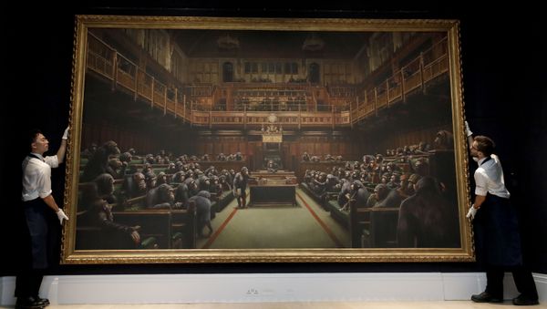 Sotheby's employees hold a painting by anonymous street artist Banksy on display at Sotheby's auction rooms in London, Friday, Sept. 27, 2019. The painting will be offered for sale on Oct. 3 in the Contemporary Art Evening Auction and is estimated at 1.5-2 million UK pounds (1.8-2.5 million US dollars). - Sputnik International