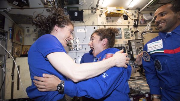In this photo made available by NASA astronaut Jessica Meir on Sept. 29, 2019, Christina H. Koch, left, and Meir greet each other after Meir's arrival on the International Space Station. On Friday, Sept. 4, 2019, NASA announced that the International Space Station’s two women will pair up for a spacewalk on Oct. 21 to plug in new batteries. - Sputnik International