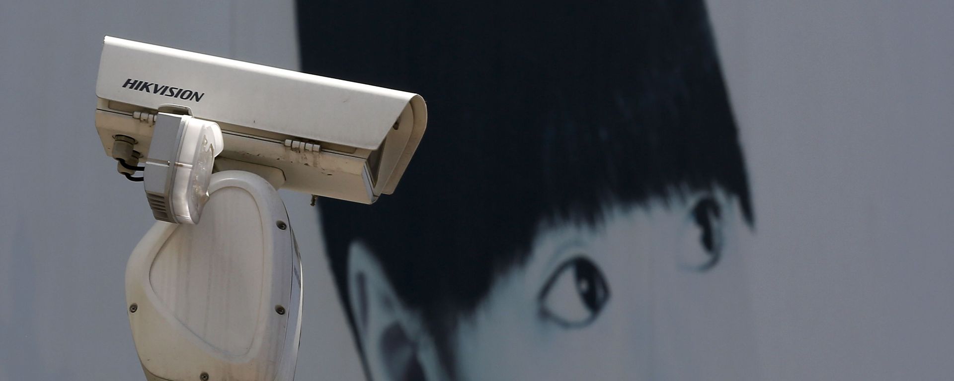 A video surveillance camera made by China's Hikvision is mounted on top of a street near a advertisement poster in Beijing. - Sputnik International, 1920, 13.03.2023
