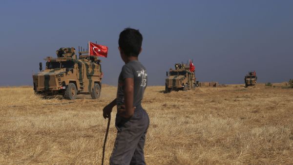 Turkish armoured vehicles patrol as they conduct a joint ground patrol with American forces in the so-called safe zone on the Syrian side of the border with Turkey, near the town of Tal Abyad, northeastern Syria, Friday, Oct. 4, 2019 - Sputnik International