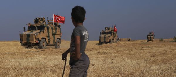 A Turkish n armored vehicles patrol as they conduct a joint ground patrol with American forces in the so-called safe zone on the Syrian side of the border with Turkey, near the town of Tal Abyad, northeastern Syria, Friday, Oct.4, 2019 A Turkish n armored vehicles patrol as they conduct a joint ground patrol with American forces in the so-called safe zone on the Syrian side of the border with Turkey, near the town of Tal Abyad, northeastern Syria, Friday, Oct.4, 2019 - Sputnik International