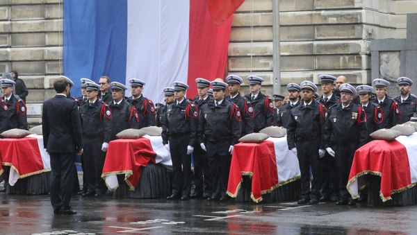 French President Emmanuel Macron stands in front of coffins during a ceremony at The Prefecture de Police de Paris (Paris Police Headquarters) in Paris on October 8, 2019, held to pay respects to the victims of an attack at the prefecture on October 4, 2019. - Sputnik International