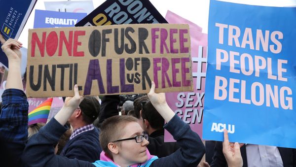 LGBTQ activists and supporters hold a rally outside the U.S. Supreme Court as it hears arguments in a major LGBT rights case on whether a federal anti-discrimination law that prohibits workplace discrimination on the basis of sex covers gay and transgender employees in Washington, U.S., October 8, 2019. - Sputnik International