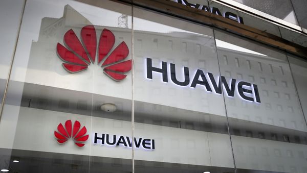 FILE - In this 29 January 2019 file photo, the logos of Huawei are displayed at its retail shop window reflecting the Ministry of Foreign Affairs office in Beijing - Sputnik International
