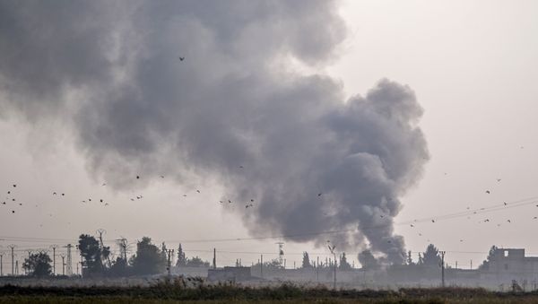 Smoke rises from the Syrian town of Tal Abyad after Turkish bombings, in a picture taken from the Turkish side of the border near Akcakale in the Sanliurfa province on October 9, 2019. - Sputnik International