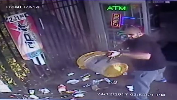 Saf Ahmad, the owner of a Lauderhill-area Kwick Pick, is seen firing an AK-47 at a customer - Sputnik International