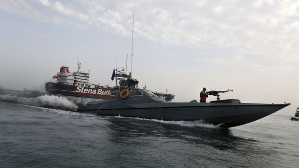 In this July 21, 2019 file photo, a speedboat of the Iran's Revolutionary Guard moves around a British-flagged oil tanker, the Stena Impero, which was seized by the Guard, in the Iranian port of Bandar Abbas.  - Sputnik International
