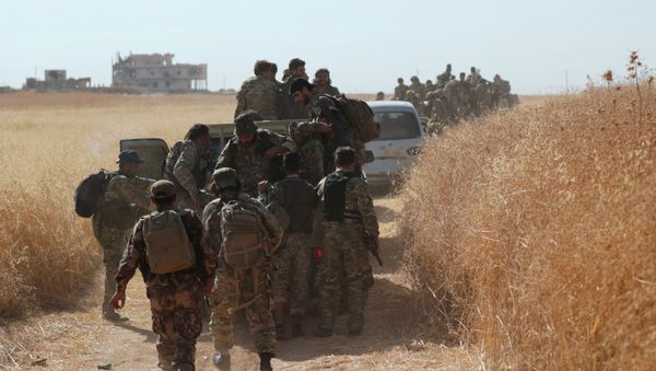 Turkey-backed Syrian rebel fighters are seen together in the village of Yabisa, near the Turkish-Syrian border, Syria, October 12, 2019.  - Sputnik International