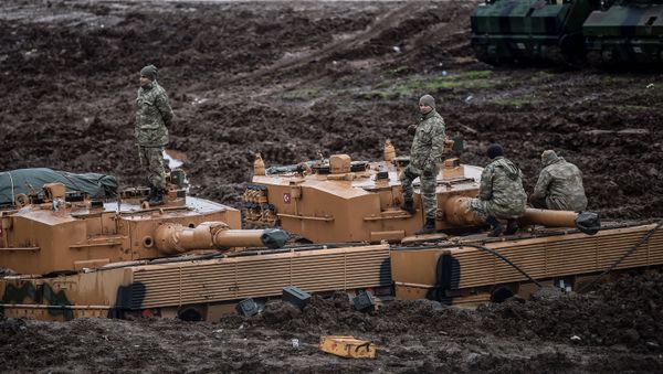 German-made Turkish Leopard 2A4 battle tanks are stationed in a field near the Syrian border at Hassa, in Hatay province on 25 January 2018, as part of operation Olive Branch. - Sputnik International