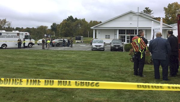 In this photo provided by WMUR-TV, police stand outside the New England Pentecostal Church after reports of a shooting on Saturday, Oct. 12, 2019, in Pelham, N.H. In this photo provided by WMUR-TV, police stand outside the New England Pentecostal Church after reports of a shooting on Saturday, Oct. 12, 2019, in Pelham, N.H. - Sputnik International