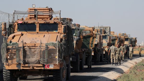 Turkish soldiers stand near military trucks in the village of Yabisa, near the Turkish-Syrian border, Syria, October 12, 2019. REUTERS/Khalil Ashawi - Sputnik International