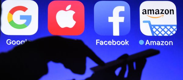 This photograph taken on September 28, 2017, shows a smartphone being operated in front of GAFA logos (acronym for Google, Apple, Facebook and Amazon web giants) as background in Hйdй-Bazouges, western France This photograph taken on September 28, 2017, shows a smartphone being operated in front of GAFA logos (acronym for Google, Apple, Facebook and Amazon web giants) as background in Hйdй-Bazouges, western France - Sputnik International