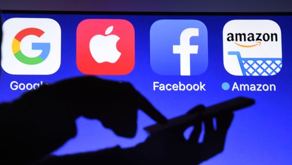 This photograph taken on September 28, 2017, shows a smartphone being operated in front of GAFA logos (acronym for Google, Apple, Facebook and Amazon web giants) as background in Hйdй-Bazouges, western France - Sputnik International