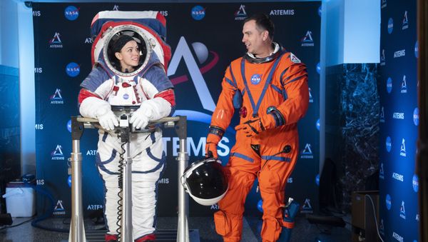 The two NASA spacesuit ​prototypes for lunar exploration, one for launch and re-entry aboard the agency's Orion spacecraft, known as the Orion Crew Survival Suit, is worn by Dustin Gohmert, right, and one for exploring the surface of the Moon's South Pole, known as the Exploration Extravehicular Mobility Unit (xEMU) is worn by Kristine Dans on Tuesday, Oct. 15, 2019, at NASA Headquarters in Washington - Sputnik International