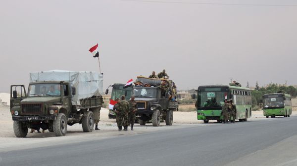 A convoy of military vehicles and transporting Syrian regime troops are stationed on the outskirts of the northern Syrian border town of Kobane (also known as Ain Arab) on October 16, 2019 A convoy of military vehicles and transporting Syrian regime troops are stationed on the outskirts of the northern Syrian border town of Kobane (also known as Ain Arab) on October 16, 2019 - Sputnik International