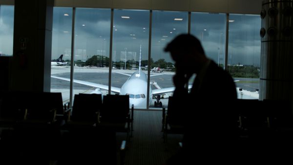 A man walks along the new terminal at the international airport Galeao, which is expected to receive 1.5 million passengers during the Olympic Games, during its opening ceremony in Rio de Janeiro, Brazil, May 19, 2016. - Sputnik International