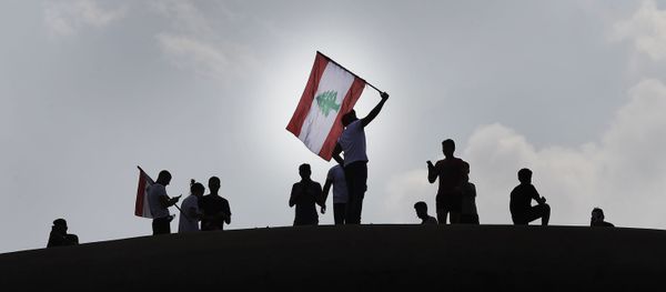 Anti-government protesters wave a Lebanese flag, as they stand on the Dome City Center known as The Egg, an unfinished cinema leftover from the civil war, as they watch other protesters, in downtown Beirut, Lebanon, Sunday, Oct. 20, 2019. Anti-government protesters wave a Lebanese flag, as they stand on the Dome City Center known as The Egg, an unfinished cinema leftover from the civil war, as they watch other protesters, in downtown Beirut, Lebanon, Sunday, Oct. 20, 2019. - Sputnik International