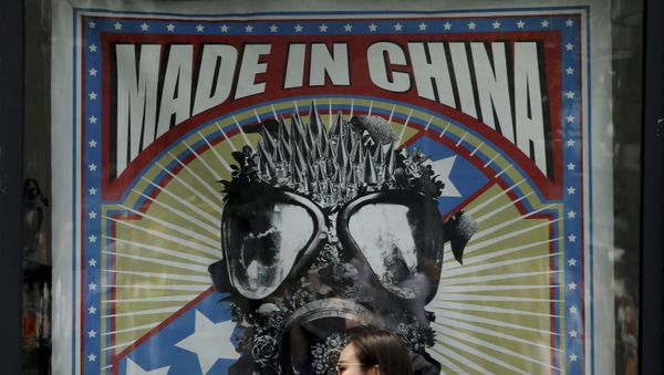 Women walk by a fashion boutique displaying its advertising banner at the capital city's popular shopping mall in Beijing, Tuesday, June 25, 2019 - Sputnik International