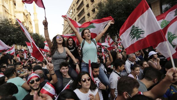 Anti-government protesters shout slogans in Beirut, Lebanon, Sunday, Oct. 20, 2019. Tens of thousands of Lebanese protesters of all ages gathered Sunday in major cities and towns nationwide, with each hour bringing hundreds more people to the streets for the largest anti-government protests yet in four days of demonstrations. - Sputnik International