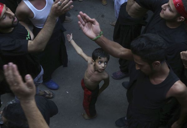 A Shiite Muslim child beats his chest next to his father during a procession to mark the end of the 40 day mourning period following the anniversary of the 7th century death of Imam Hussein, the Prophet Muhammad's grandson and one of Shiite Islam's most beloved saints, in Lahore, Pakistan, Sunday, Oct. 20, 2019. A Shiite Muslim child beats his chest next to his father during a procession to mark the end of the 40 day mourning period following the anniversary of the 7th century death of Imam Hussein, the Prophet Muhammad's grandson and one of Shiite Islam's most beloved saints, in Lahore, Pakistan, Sunday, Oct. 20, 2019. - Sputnik International