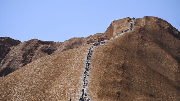 Tourists climb Uluru, formerly known as Ayers Rock, at Uluru-Kata Tjuta National Park in the Northern Territory, Australia, October 25, 2019. Friday is the last day people will be able to climb Uluru - Sputnik International