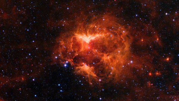 This infrared image from NASA's Spitzer Space telescope shows a cloud of gas and dust carved out by a massive star. A drawing overlaid on the image reveals why researchers nicknamed this region the Jack-o'-lantern Nebula. - Sputnik International