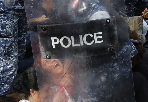 A riot policeman removes an anti-government protester who is blocking a main highway with her body, in Beirut, Lebanon, Saturday, Oct. 26, 2019. Lebanese security forces pushed and dragged away protesters who refused to move from roadblocks in central Beirut on Saturday, to reopen roads closed during a campaign of civil disobedience.  - Sputnik International