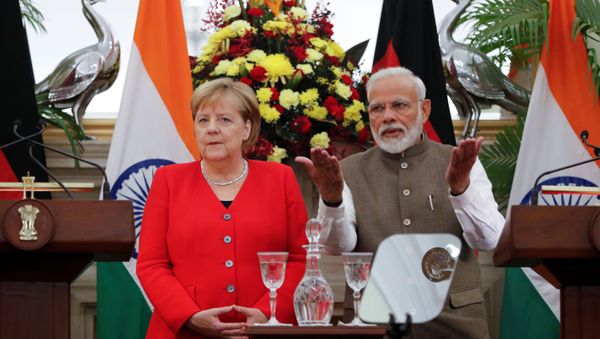 German Chancellor Angela Merkel and India's Prime Minister Narendra Modi are seen before making a joint statement at Hyderabad House in New Delhi, India, November 1, 2019 - Sputnik International
