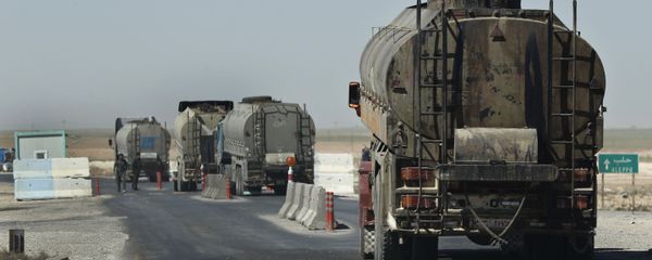 This 4 April 2018 photo shows a convoy of oil trucks passing a Kurdish police (Assayesh) checkpoint, as they move fuel produced in Kurdish-held areas in the east to other areas controlled by the same US-backed group in the west, on a highway in Hasakah province, Syria. This 4 April 2018 photo shows a convoy of oil trucks passing a Kurdish police (Assayesh) checkpoint, as they move fuel produced in Kurdish-held areas in the east to other areas controlled by the same US-backed group in the west, on a highway in Hasakah province, Syria. - Sputnik International