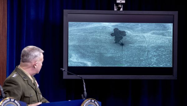Video of the Abu Bakr al-Baghdadi raid is displayed as US Central Command Commander Marine Gen. Kenneth McKenzie speaks, Wednesday, Oct. 30, 2019, at a joint press briefing at the Pentagon in Washington. - Sputnik International
