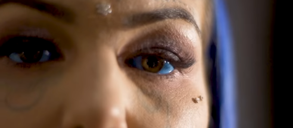 A screengrab of Amer Luke's video interview showing her tattooed blue eyes. A screengrab of Amer Luke's video interview showing her tattooed blue eyes. - Sputnik International