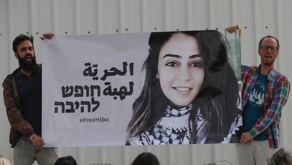 Israeli activists protest in solidarity with Jordanian Heba al-Labadi (portrait), who is currently in Israeli custody and has been on hunger strike, outside Ofer Prison during her court hearing in the Israeli-occupied West Bank on October 28, 2019. Israeli activists protest in solidarity with Jordanian Heba al-Labadi (portrait), who is currently in Israeli custody and has been on hunger strike, outside Ofer Prison during her court hearing in the Israeli-occupied West Bank on October 28, 2019. - Sputnik International