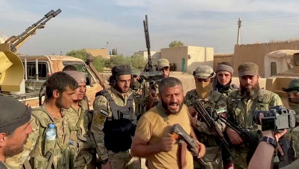 A Syrian rebel fighter declares the liberation of Mehrabli village from the Syrian Democratic Forces (SDF) near Tal Abyad, Syria, October 11, 2019, in this still image obtained from video - Sputnik International