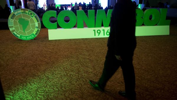 A member of the South American Football Confederation, CONMEBOL, walks in the hotel lounge where the CONMEBOL congress is taking place in Lima, Peru - Sputnik International