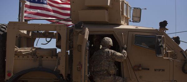 In this Sept. 8, 2019, photo, a U.S. soldier climbs into an armored vehicle during the first American-Turkish joint patrol in the so-called safe zone on the Syrian side of the border with Turkey near Tal Abyad, Syria In this Sept. 8, 2019, photo, a U.S. soldier climbs into an armored vehicle during the first American-Turkish joint patrol in the so-called safe zone on the Syrian side of the border with Turkey near Tal Abyad, Syria - Sputnik International