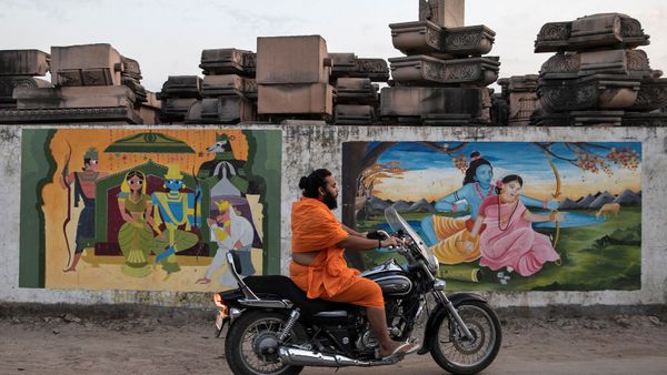 A Hindu priest rides past a workshop where the pillars that Hindu nationalist group Vishva Hindu Parishad (VHP) say will be used to build a Ram temple at the disputed religious site are kept, in Ayodhya, India, October 22, 2019 - Sputnik International