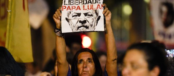 A woman holds up a sign that reads in Portuguese Freedom for Lula, referring to former jailed president Luis Inacio Lula da Silva, during a protest against Brazil's president Jair Bolsonaro to demand an investigation into the 2018 murder of city councilwoman Marielle Franco in Rio de Janeiro, Brazil, Tuesday, Nov. 5, 2019.  - Sputnik International