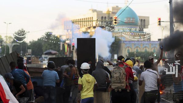 Iraqi riot police fire tear gas to disperse anti-government protesters during ongoing protests in central Baghdad, Iraq, Saturday, Nov. 9, 2019. Mass protests erupted in Baghdad and across southern Iraq last month, calling for the overhaul of the political system established after the 2003 U.S.-led invasion. Iraqi riot police fire tear gas to disperse anti-government protesters during ongoing protests in central Baghdad, Iraq, Saturday, Nov. 9, 2019. Mass protests erupted in Baghdad and across southern Iraq last month, calling for the overhaul of the political system established after the 2003 U.S.-led invasion. - Sputnik International