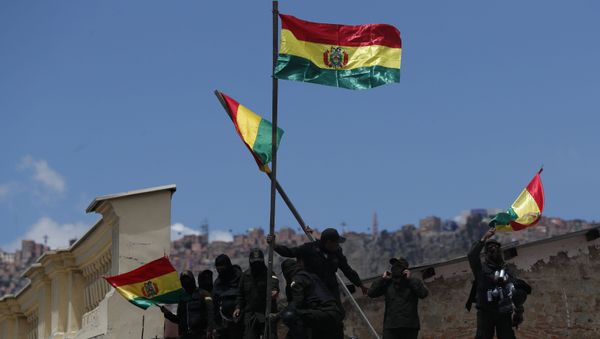 Police against the reelection of President Evo Morales stand on the rooftop of a police station just meters away from the presidential palace in La Paz - Sputnik International