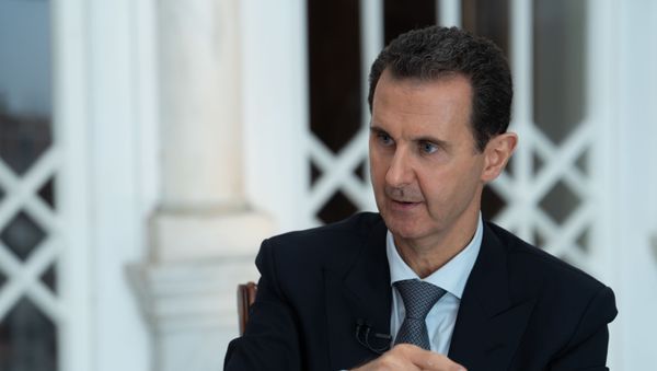 A handout picture released by the official Syrian Arab News Agency (SANA) on October 31, 2019 shows President Bashar al-Assad speaking during a special broadcast interview in Syria's capital Damascus. - Sputnik International