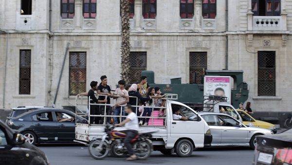People ride in the back of a pickup truck in the Syrian capital Damascus, Syria, Wednesday, July 24, 2019. People ride in the back of a pickup truck in the Syrian capital Damascus, Syria, Wednesday, July 24, 2019. - Sputnik International