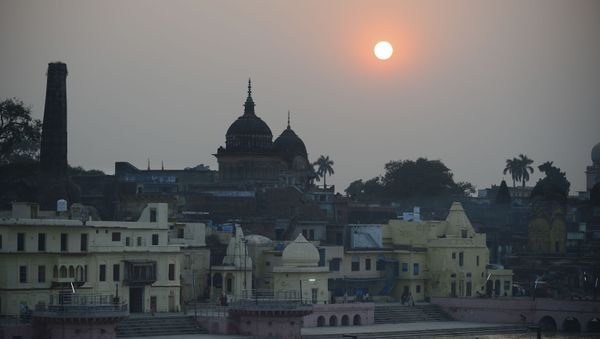 Devotees walk at Ram ki paidi Ghat during sunset on the eve of Kartik Purnima celebrations near Saryu river in Ayodhya on November 11, 2019, after Supreme Court verdict on the disputed religious site.  - Sputnik International