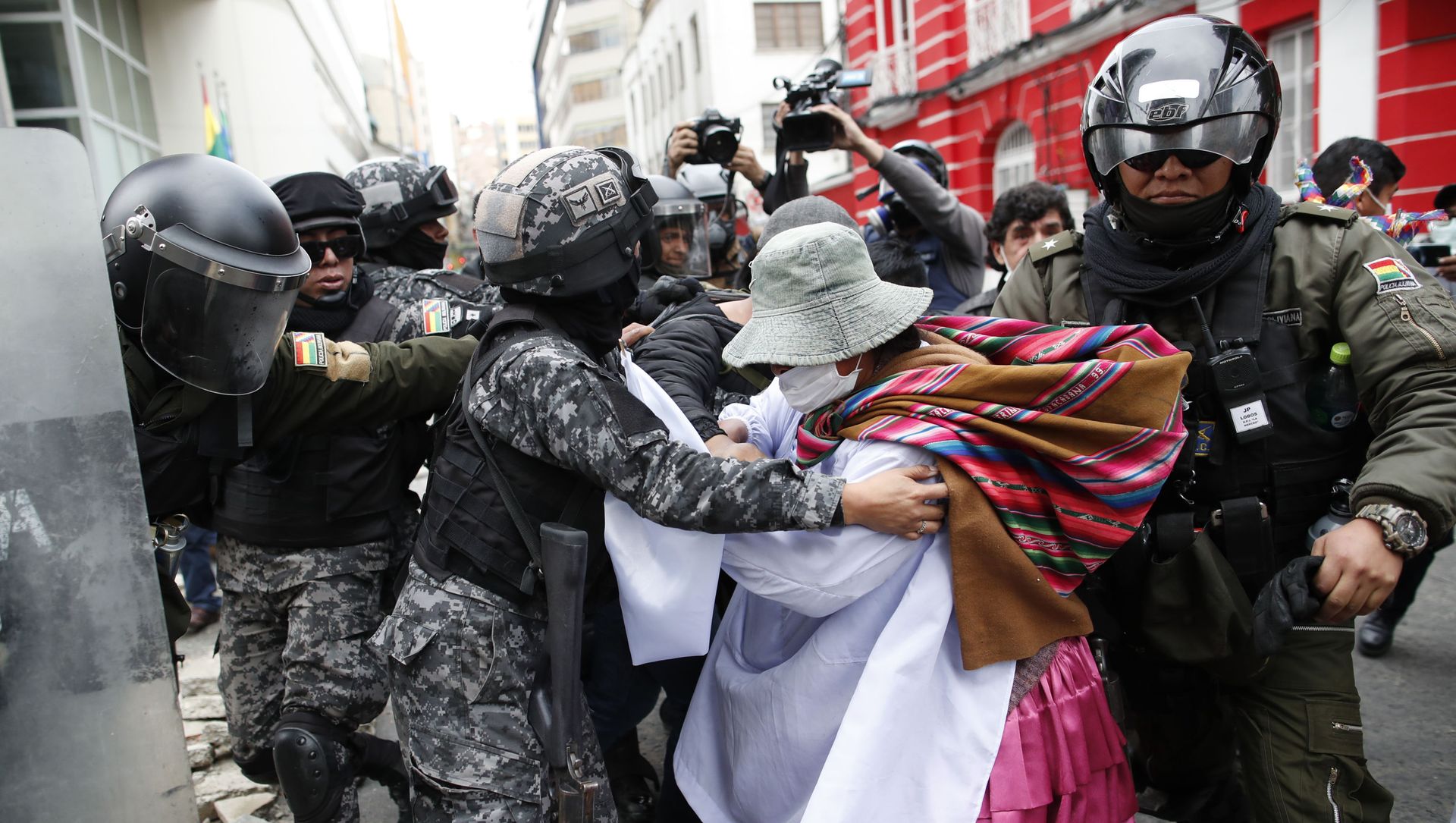 A backer of former President Evo Morales scuffles with police in La Paz, Bolivia, Wednesday, Nov. 13, 2019. The opposition senator who has claimed Bolivia's presidency Jeanine Anez, faces the challenge of stabilizing the nation and organizing national elections within three months at a time of political disputes that pushed Morales to fly off to self-exile in Mexico after 14 years in power. A backer of former President Evo Morales scuffles with police in La Paz, Bolivia, Wednesday, Nov. 13, 2019. The opposition senator who has claimed Bolivia's presidency Jeanine Anez, faces the challenge of stabilizing the nation and organizing national elections within three months at a time of political disputes that pushed Morales to fly off to self-exile in Mexico after 14 years in power. - Sputnik International, 1920, 19.06.2021