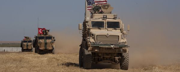 In this Sept. 8, 2019, photo, Turkish and American armored vehicles conduct the first joint patrol in the so-called safe zone on the Syrian side of the border with Turkey near Tal Abyad, Syria - Sputnik International