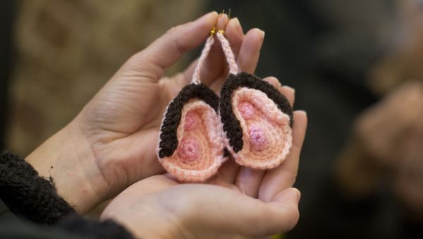 A visitor looks at a pair of crochet vulva earrings on sale during the press preview of the new Vagina Museum in Camden market, north London on November 14, 2019 - Sputnik International