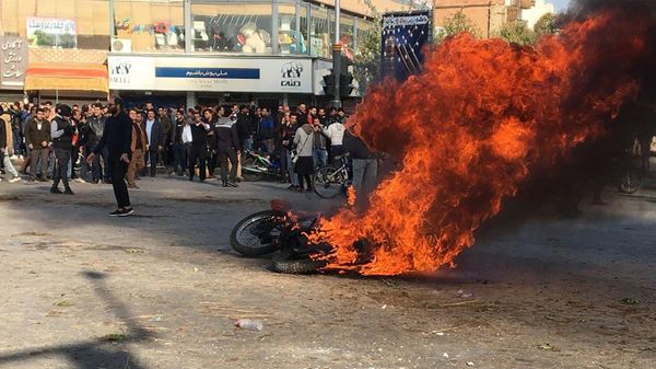 Iranian protesters gather around a burning motorcycle during a demonstration against an increase in gasoline prices in the central city of Isfahan, on November 16, 201 Iranian protesters gather around a burning motorcycle during a demonstration against an increase in gasoline prices in the central city of Isfahan, on November 16, 201 - Sputnik International