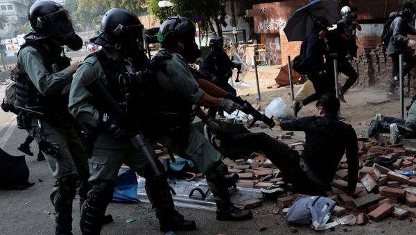 Protesters attempt to escape from tear gas while trying to leave the campus of Hong Kong Polytechnic University (PolyU) during clashes with police in Hong Kong, China November 18, 2019 - Sputnik International